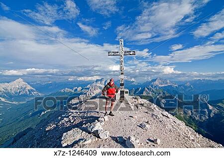 Man on the summit after climbing the Giovanni Lipella via ferrata on Tofana De Rozes in the Dolomite Mountains near the city of Cortina in northern Italy View Large Photo Image Stock Photo - Man on the summit after climbing the Giovanni Lipella via ferrata on Tofana De Rozes in the Dolomite Mountains near the city of Cortina in northern Italy. Fotosearch