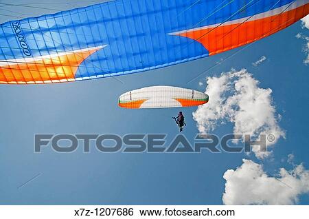Man paragliding at Le Brevent in the Aiguilles Rouges high above the city of Chamonix France View Large Photo Image Stock Photograph - Man paragliding at Le Brevent in the Aiguilles Rouges high above the city of Chamonix France. Fotosearch