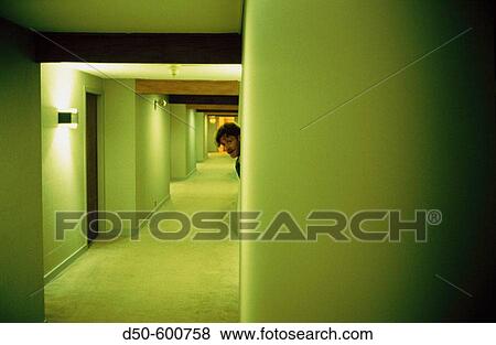Man peeking in hotel corridor View Large Photo Image Stock Photo - Man peeking in hotel corridor. Fotosearch