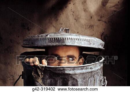 Man peering out of trash can View Large Photo Image Stock Image - Man peering out of trash can. Fotosearch