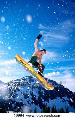 Man performing jump on snowboard against blue sky. Mt. Baker Ski Area. Washington. USA View Large Photo Image Picture - Man performing jump on snowboard against blue sky. Mt. Baker Ski Area. Washington. USA. Fotosearch