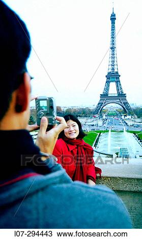 Man photographing woman with digital camera in front of the Eiffel Tower. Paris. France View Large Photo Image Stock Image - Man photographing woman with digital camera in front of the Eiffel Tower. Paris. France. Fotosearch