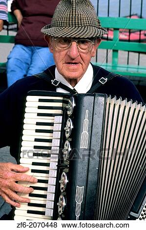 Stock Photo - Man playing accordion in Cornwall England.. Fotosearch