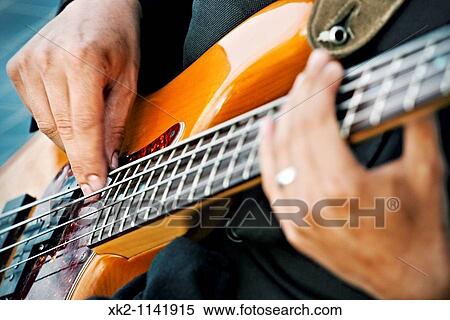 Man playing an electric guitar View Large Photo Image Stock Photography - Man playing an electric guitar. Fotosearch