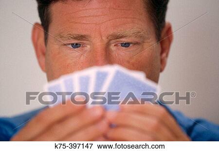 Stock Photo - man playing cards. Fotosearch