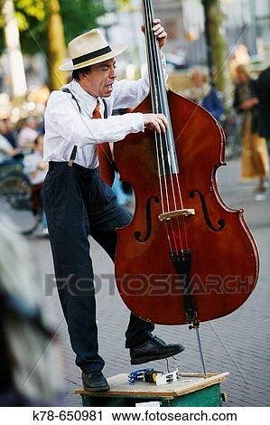 Man playing cello at Leidse Plein, Amsterdam, Holland. View Large Photo Image Stock Image - Man playing cello at Leidse Plein, Amsterdam, Holland.. Fotosearch