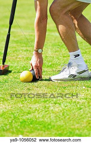 Stock Image - Man playing croquet. Fotosearch