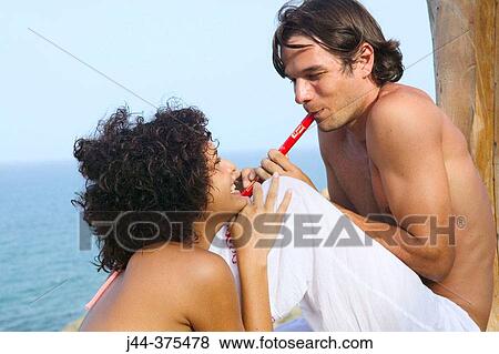 Man playing flute to girlfriend by the ocean View Large Photo Image Stock Photo - Man playing flute to girlfriend by the ocean. Fotosearch