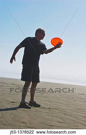 Man playing freestyle frisbee on California beach View Large Photo Image Stock Image - Man playing freestyle frisbee on California beach. Fotosearch