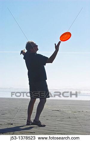 Man playing freestyle frisbee on California beach View Large Photo Image Stock Image - Man playing freestyle frisbee on California beach. Fotosearch