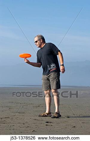Man playing freestyle frisbee on California beach View Large Photo Image Stock Photograph - Man playing freestyle frisbee on California beach. Fotosearch