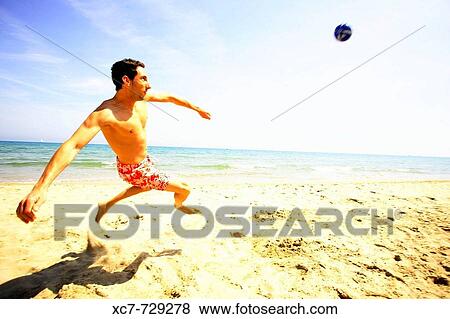 Man playing on beach View Large Photo Image Stock Photo - Man playing on beach. Fotosearch