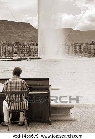 man playing piano on Lake Geneva beach called Paquis, Geneva, Switzerland View Large Photo Image Stock Photo - man playing piano on Lake Geneva beach called Paquis, Geneva, Switzerland. Fotosearch
