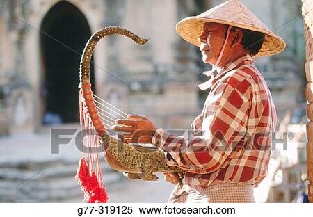 Man playing the Burmese harp. Bagan. Myanmar (Burma) View Large Photo Image Stock Photography - Man playing the Burmese harp. Bagan. Myanmar (Burma). Fotosearch