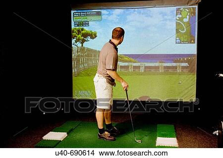Man playing virtual golf View Large Photo Image Picture - Man playing virtual golf. Fotosearch