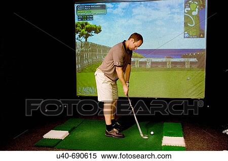 Man playing virtual golf View Large Photo Image Stock Photography - Man playing virtual golf. Fotosearch