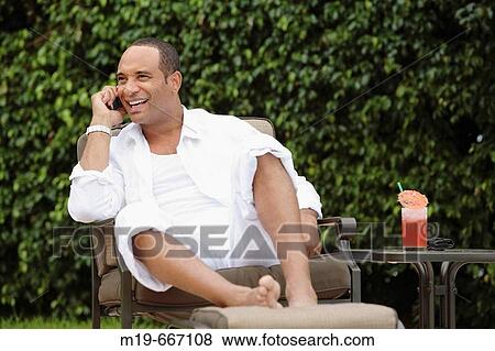 Man poolside on cell phone View Large Photo Image Stock Photo - Man poolside on cell phone. Fotosearch