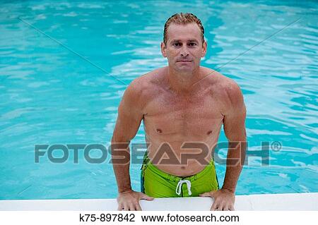 Stock Image - Man poolside. Fotosearch