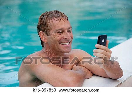 Stock Image - Man poolside. Fotosearch