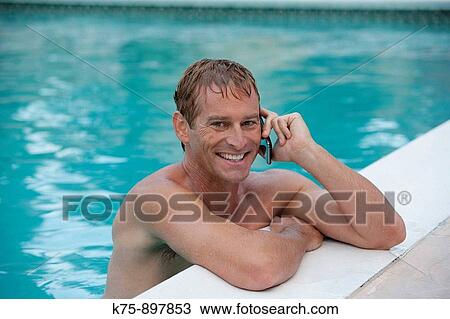 Stock Image - Man poolside. Fotosearch