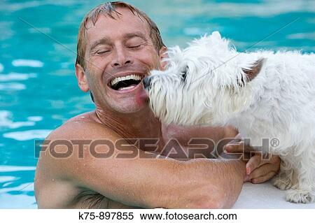 Man poolside with pet dog View Large Photo Image Stock Photography - Man poolside with pet dog. Fotosearch