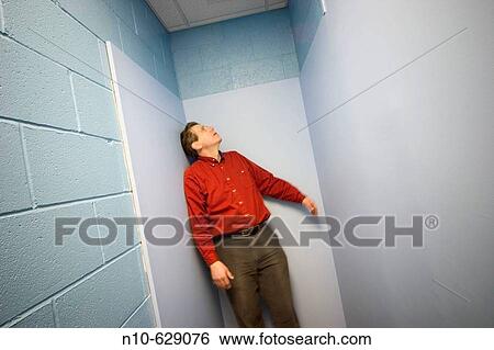 Man posing at the end of a hallway. View Large Photo Image Stock Photograph - Man posing at the end of a hallway.. Fotosearch