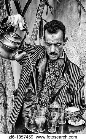 Man pouring tea for sale in Medina area of Tunis Tunisia of Northern Africa View Large Photo Image Stock Photo - Man pouring tea for sale in Medina area of Tunis Tunisia of Northern Africa. Fotosearch