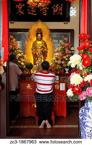 Stock Image - Man praying, Kek Lok Si Temple, Penang, Malaysia.. Fotosearch