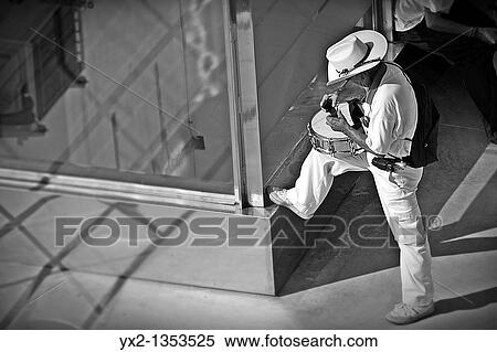 Stock Photography - Man preparing drum. Fotosearch