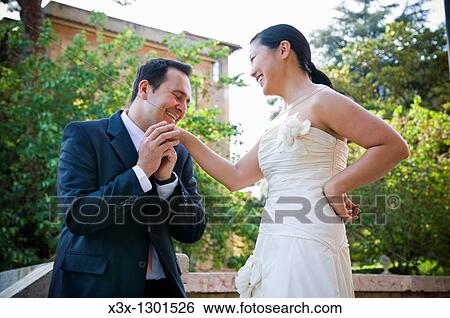 Man proposing to Asian woman outdoors View Large Photo Image Stock Photograph - Man proposing to Asian woman outdoors. Fotosearch