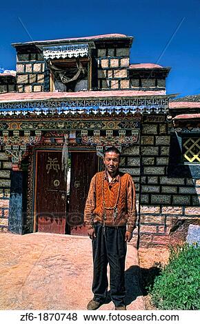 Man proudly stands in front of his home in capital city of Lhasa Tibet China View Large Photo Image Stock Photo - Man proudly stands in front of his home in capital city of Lhasa Tibet China. Fotosearch