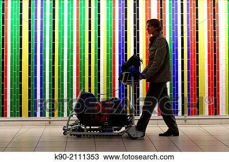 Man pusching a trolley with luggage, passing by a wall with colorful tiles, Johannesburg, South Africa, Africa. View Large Photo Image Stock Image - Man pusching a trolley with luggage, passing by a wall with colorful tiles, Johannesburg, South Africa, Africa.. Fotosearch