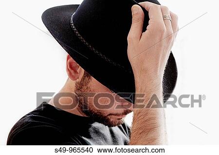 man putting his hat View Large Photo Image Stock Image - man putting his hat. Fotosearch