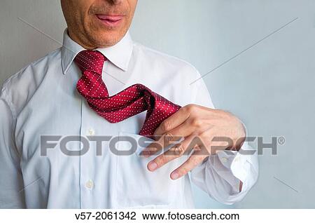 Man putting his tie into the pocket of his shirt. Close view. View Large Photo Image Stock Image - Man putting his tie into the pocket of his shirt. Close view.. Fotosearch