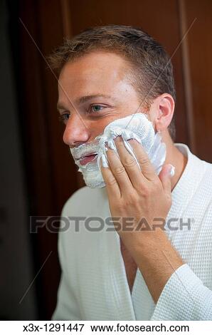 Stock Photo - Man putting shaving cream on face. Fotosearch
