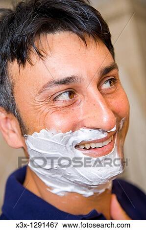 Man putting shaving cream on face View Large Photo Image Stock Photo - Man putting shaving cream on face. Fotosearch