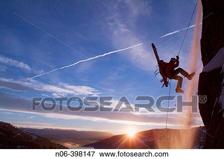 Man rappelling during small avalanche with skis on his back on Donner Summit, California. USA View Large Photo Image Stock Photo - Man rappelling during small avalanche with skis on his back on Donner Summit, California. USA. Fotosearch
