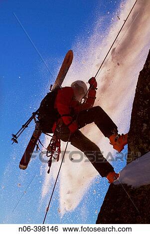 Man rappelling during small avalanche with skis on his back on Donner Summit, California. USA View Large Photo Image Stock Photograph - Man rappelling during small avalanche with skis on his back on Donner Summit, California. USA. Fotosearch