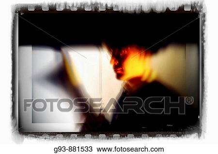 Stock Image - Man reading and holding an umbrella. Fotosearch