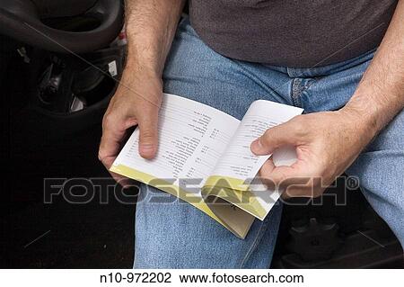 Man reading his car's manual while sitting in his car View Large Photo Image Stock Image - Man reading his car's manual while sitting in his car. Fotosearch