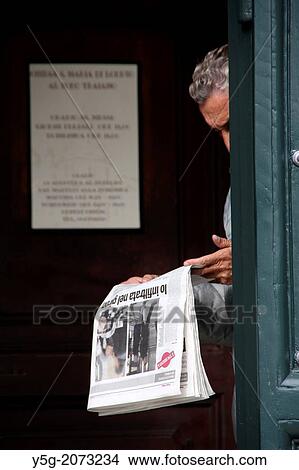 man reading newspaper in church door in rome italy. View Large Photo Image Picture - man reading newspaper in church door in rome italy.. Fotosearch