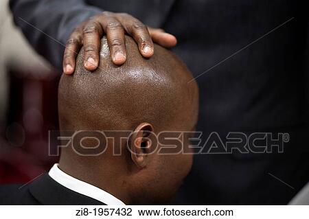 Stock Image - Man recieves a blessing, Accra, Ghana. Fotosearch