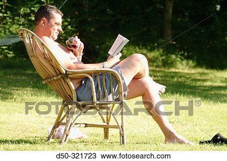 Man relaxes with a book and a glass of wine in the sun. Sweden View Large Photo Image Stock Image - Man relaxes with a book and a glass of wine in the sun. Sweden. Fotosearch