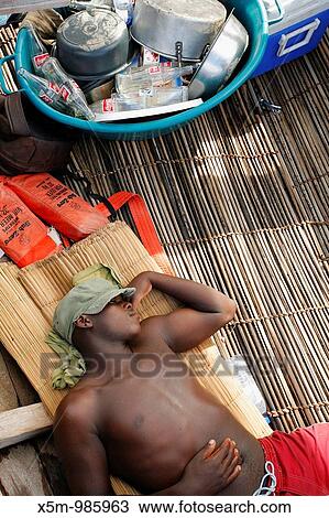 Man resting in the bottom of a dhow in Mozambique View Large Photo Image Stock Image - Man resting in the bottom of a dhow in Mozambique. Fotosearch