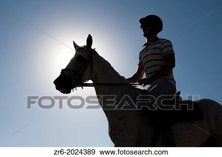 Man rides a horse under the sun, Alicante, Spain. View Large Photo Image Stock Photo - Man rides a horse under the sun, Alicante, Spain.. Fotosearch