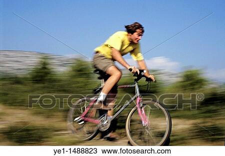 Man riding a mountain bike on a dirt road. View Large Photo Image Stock Image - Man riding a mountain bike on a dirt road.. Fotosearch