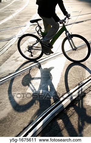 man riding bike in city View Large Photo Image Stock Image - man riding bike in city. Fotosearch