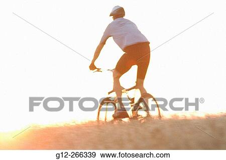 Stock Photo - Man riding mountain bike. Fotosearch