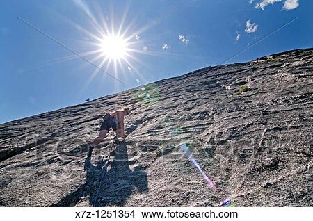Man rock climbing a route called Memorial which is rated 5, 8 and located on Slick Rock near the city of McCall in the Salmon River Mountains of central Idaho View Large Photo Image Picture - Man rock climbing a route called Memorial which is rated 5, 8 and located on Slick Rock near the city of McCall in the Salmon River Mountains of central Idaho. Fotosearch