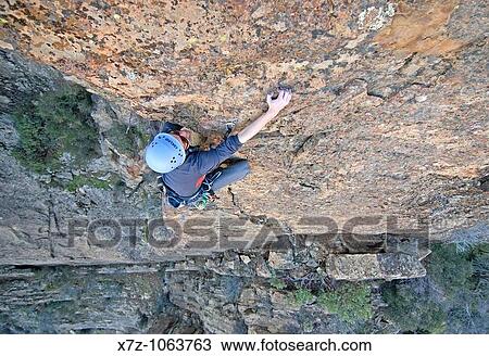 Man rock climbing a route called Permanent Income Hypothesis which is rated 5, 9 and located at The Fortress in the Sespe Mountains of southern California USA View Large Photo Image Stock Image - Man rock climbing a route called Permanent Income Hypothesis which is rated 5, 9 and located at The Fortress in the Sespe Mountains of southern California USA. Fotosearch